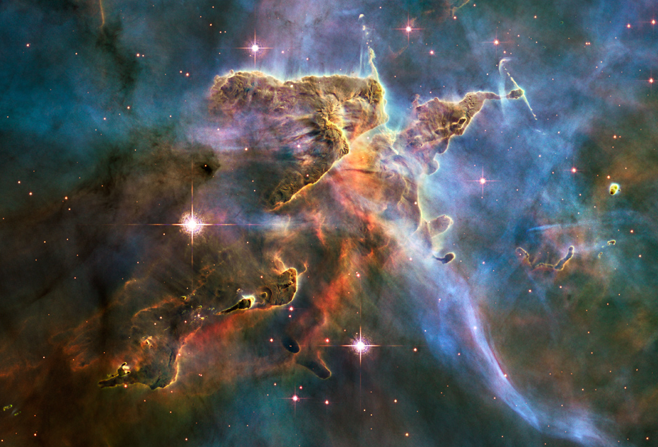 Hubble telescope image of stars forming inside a cloud of cold hydrogen gas and dust in the Carina Nebula