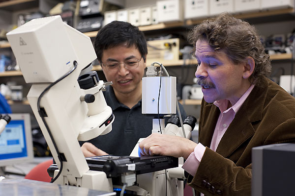 Photo: Shiguo Zhou (left) and genetics and chemistry Professor David C. Schwartz