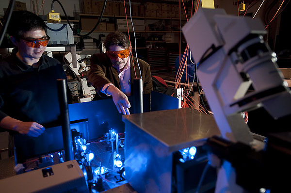 Photo: Researchers looking at laser