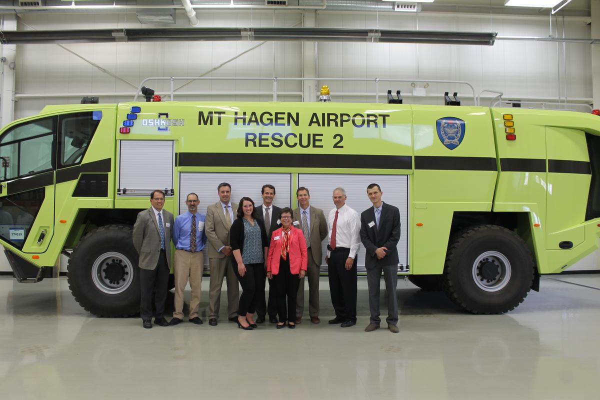 Photo: Officials standing in front of firefighting vehicle