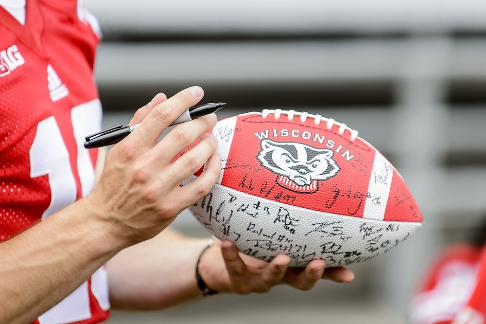 Photo: Football player signing ball