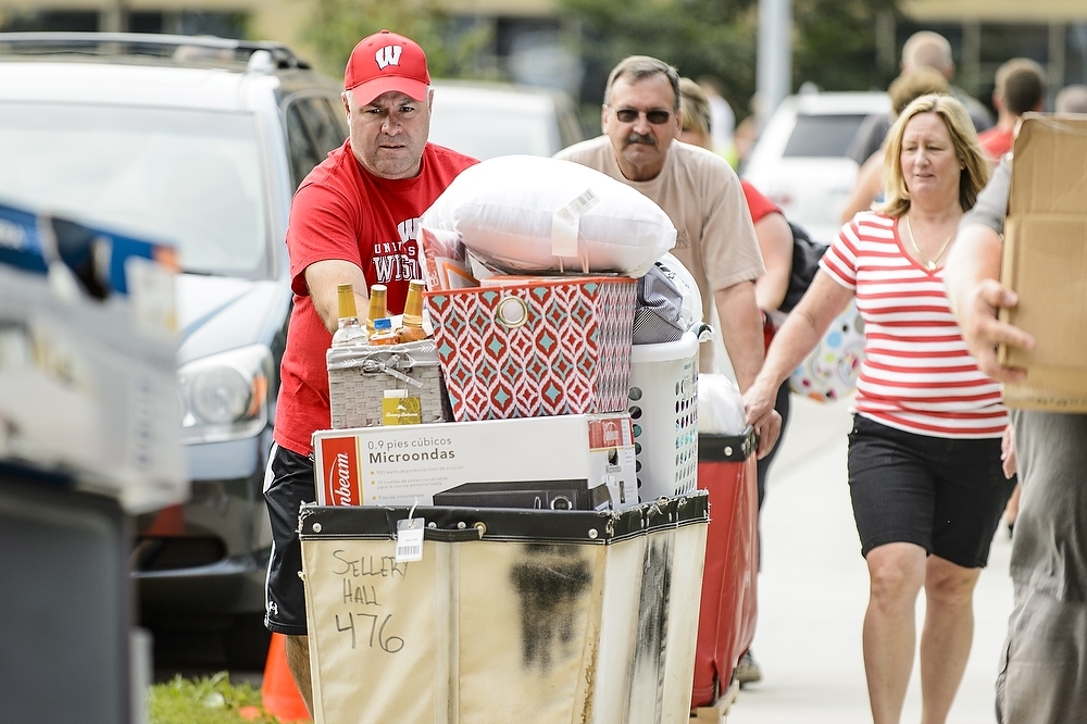 Photo: Dad pushing cart full of belongings