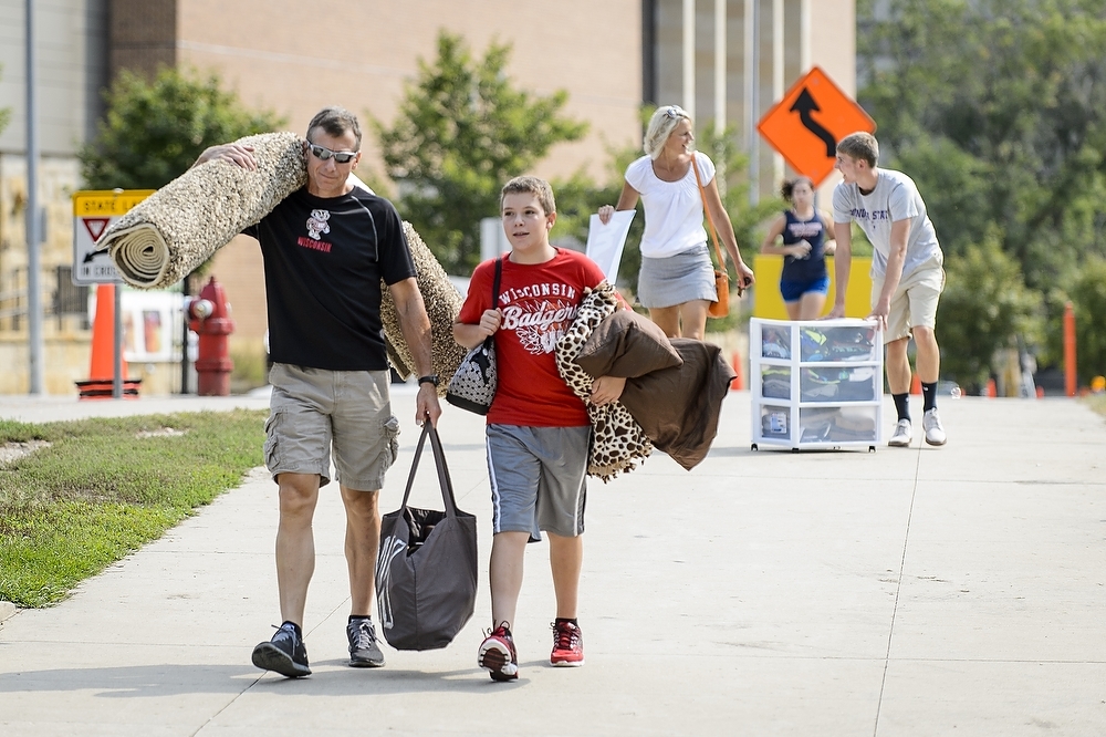 Photo: Man carrying roll of carpeting