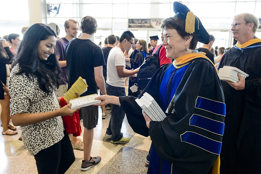 Photo: Sarah Mangelsdorf giving book to student