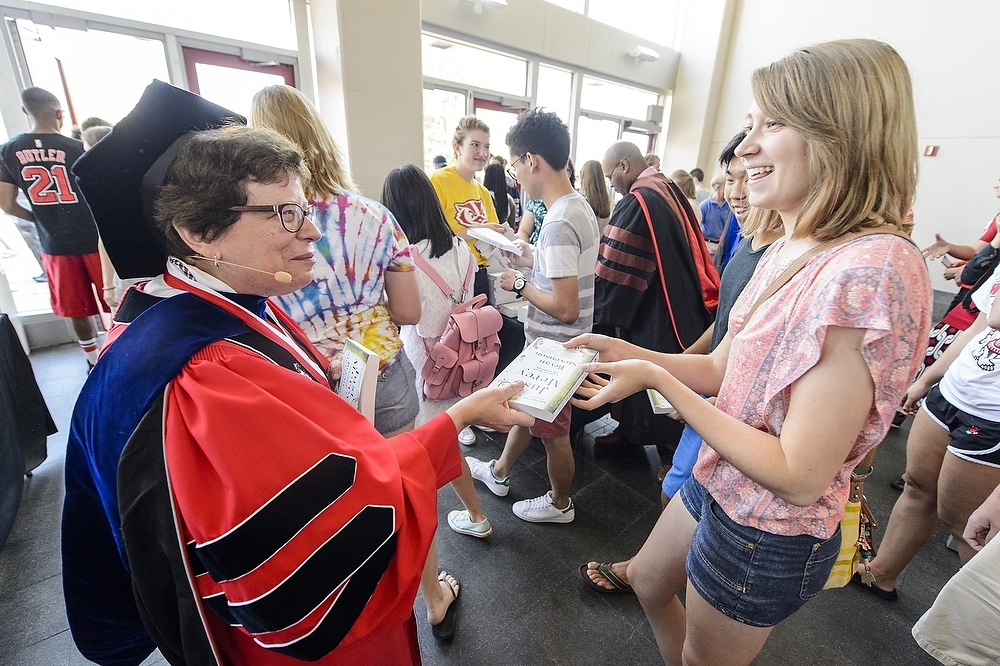 Photo: Rebecca Blank handing book to student