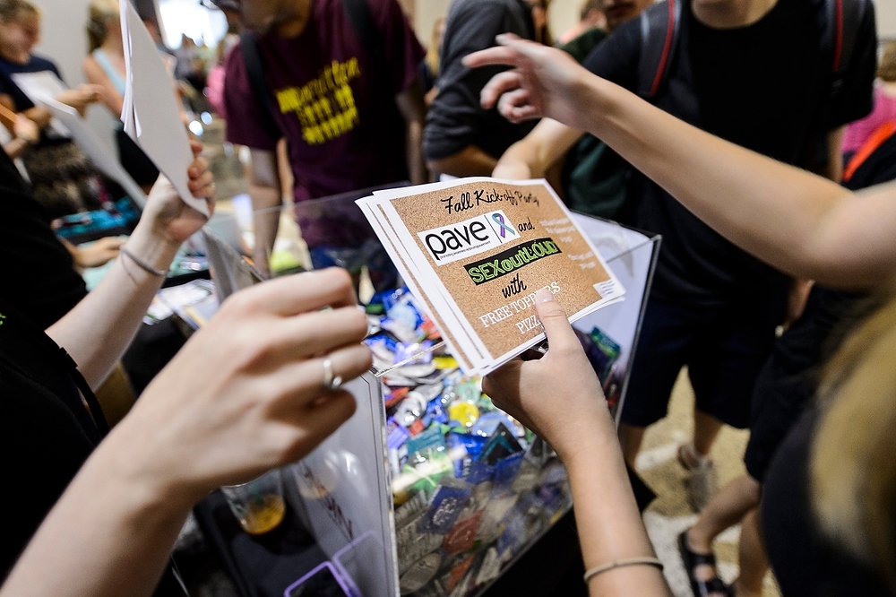 Photo: Members of Promoting Awareness, Victim Empowerment (PAVE) and Sex Out Loud hand out information about an upcoming event