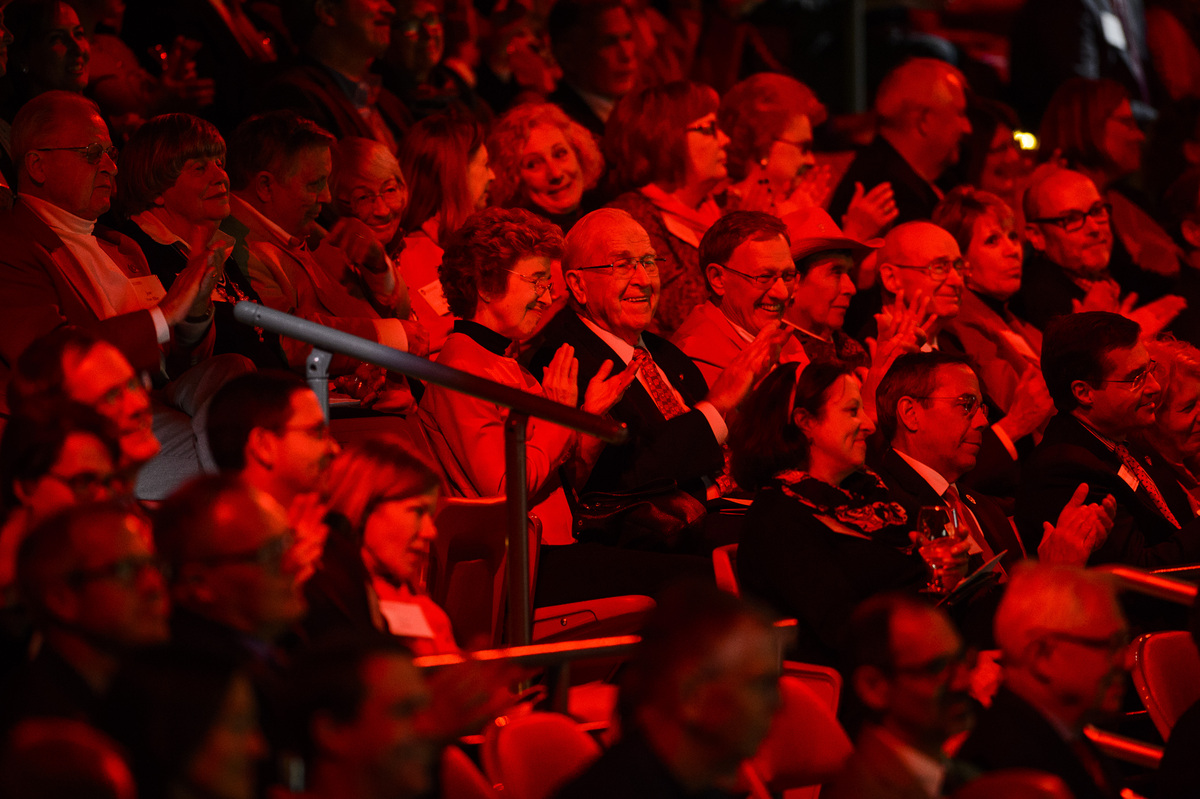 Photo: Audience members bathed in red light