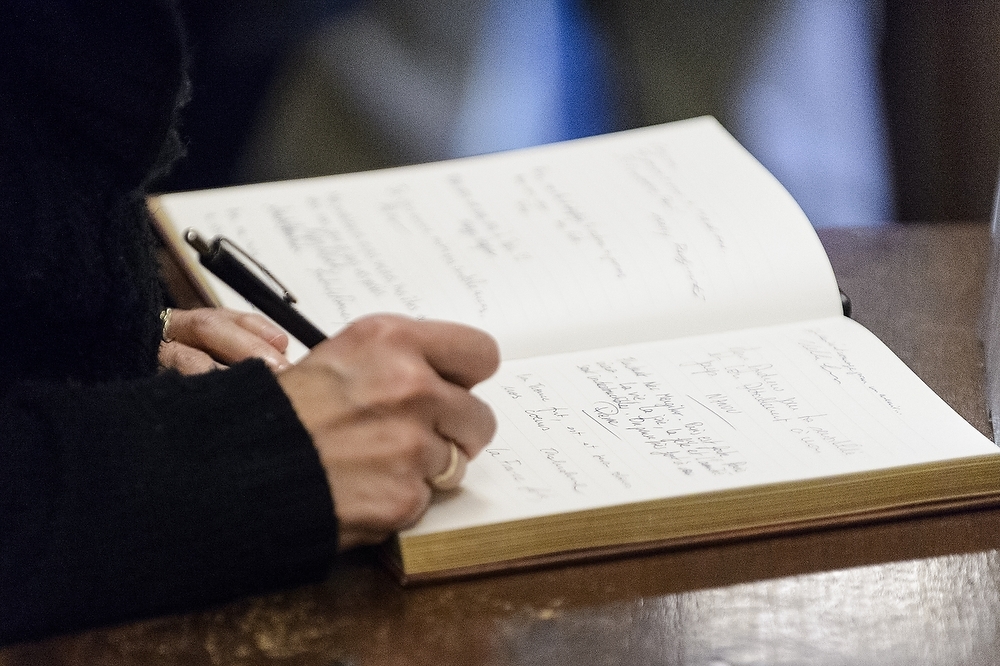 Photo: People signing a guest book