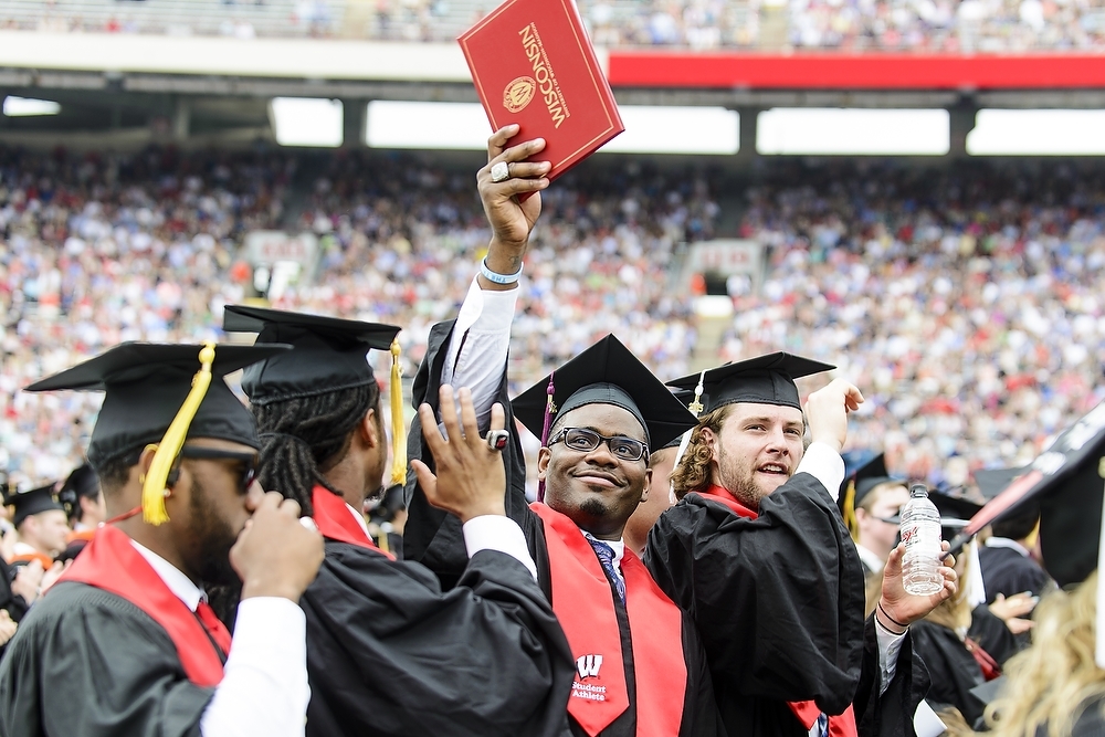 Photo: Student raising diploma