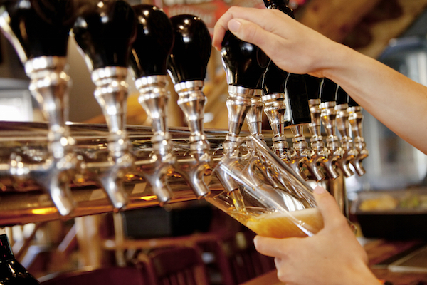 Photo: Glass of beer being poured from tap