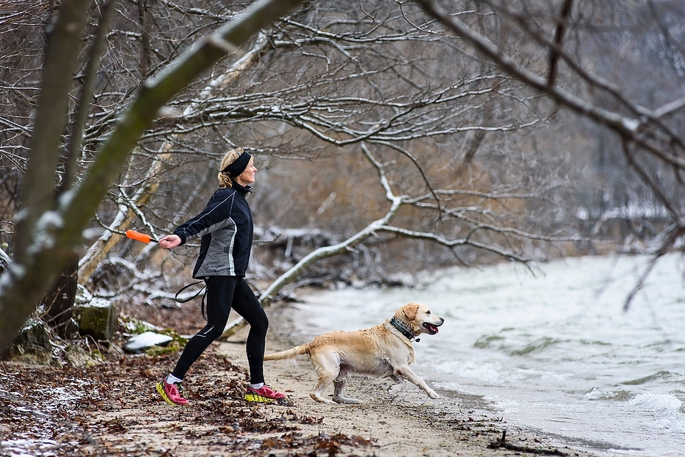 Photo: Woman and soaked dog by lake