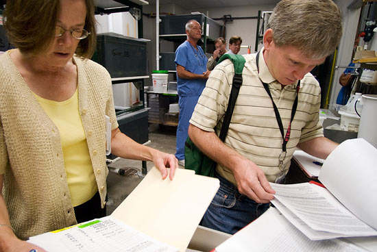 Photo of people reviewing lab records