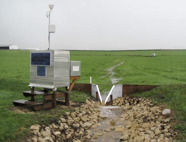 Rain water runoff from an agricultural field is channeled through a flume at the Pioneer Research Farm in Platteville, Wis.
