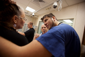 Photo: resident consoling family member played by actor