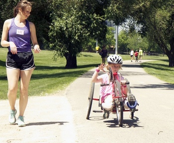 Photo: child riding adapted recumbent bike