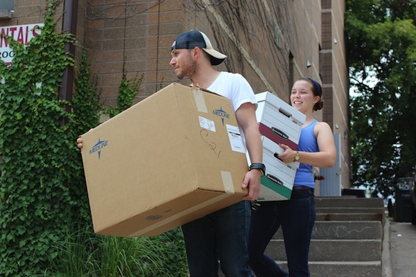 Photo: students carrying moving boxes