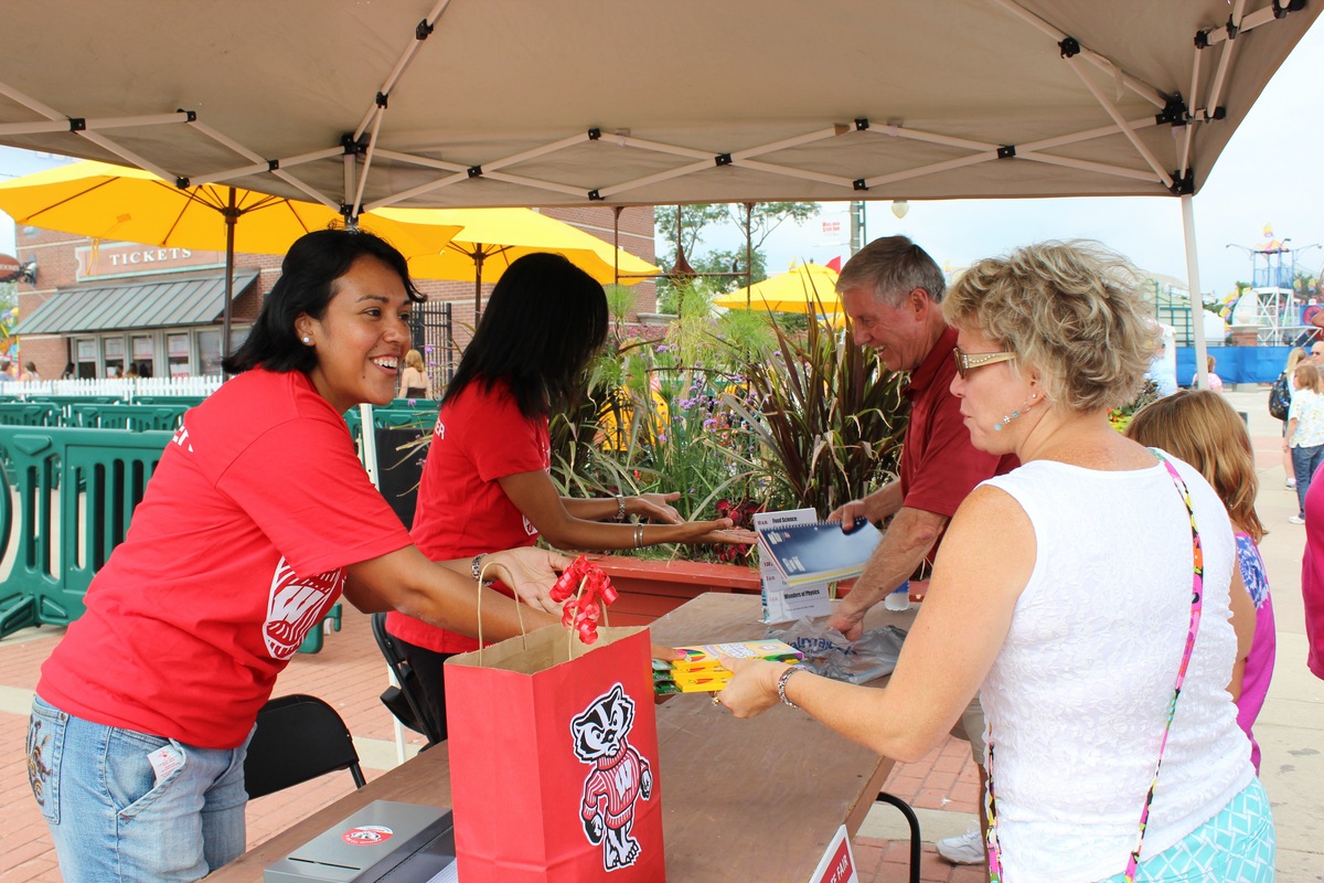 Photo: people donating school supplies at fair