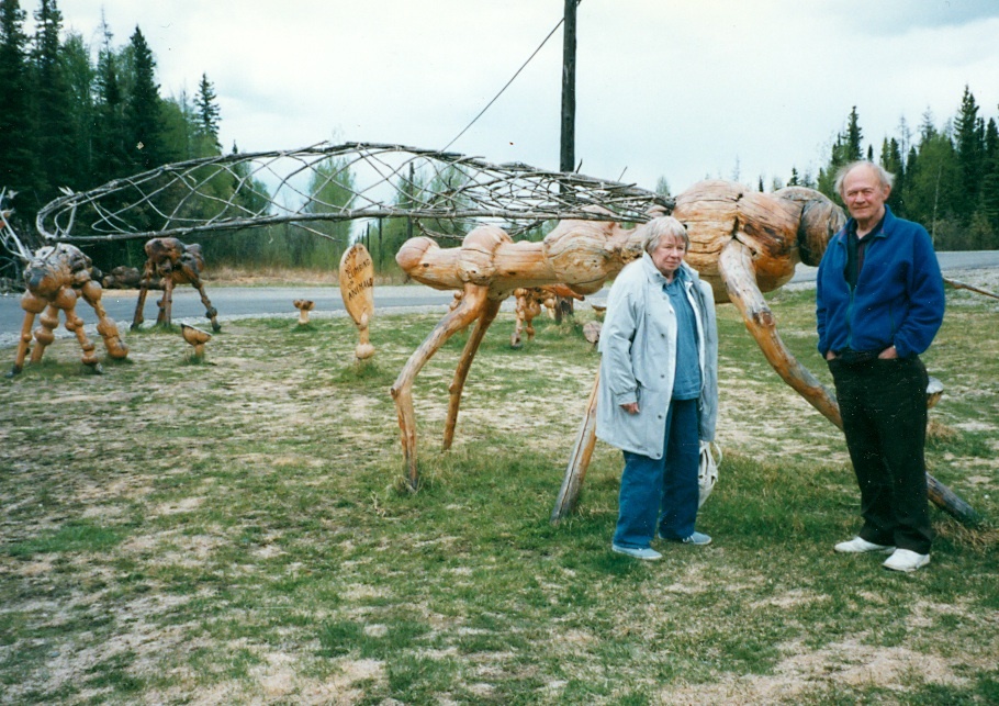 Photo: Gene and Lou DeFoliart in front of large bug sculpture