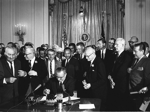 LBJ signs Civil Rights Act of 1964