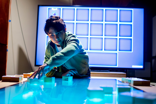 Photo: middle school child at game table