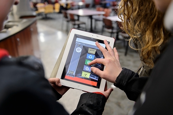 Photo: students playing game on tablet