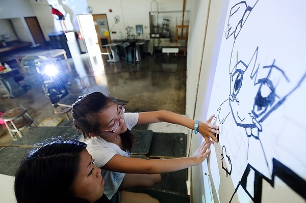 Photo: students drawing mural