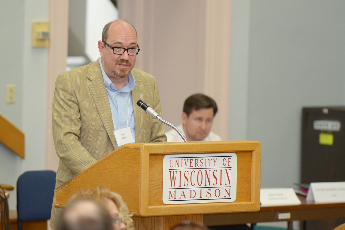 Photo: John Lease speaking at podium