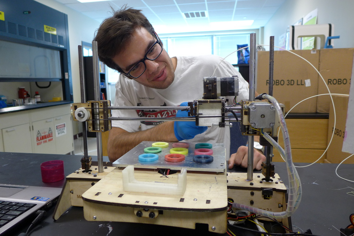 Photo: Chase Haider adjusts a commercial 3-D printer