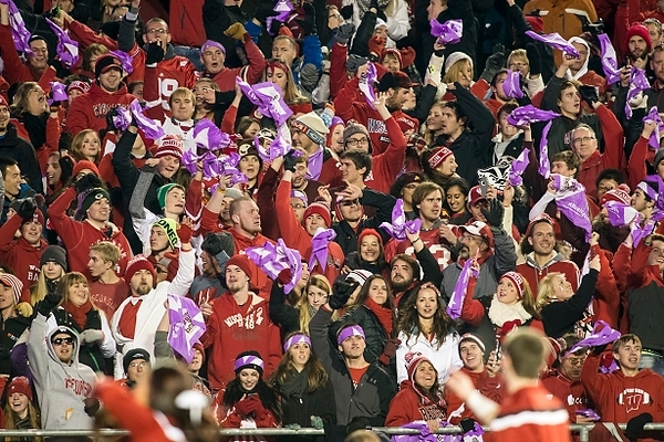 Photo: Badger fans wave purple "team up to axe epilepsy" rally towels