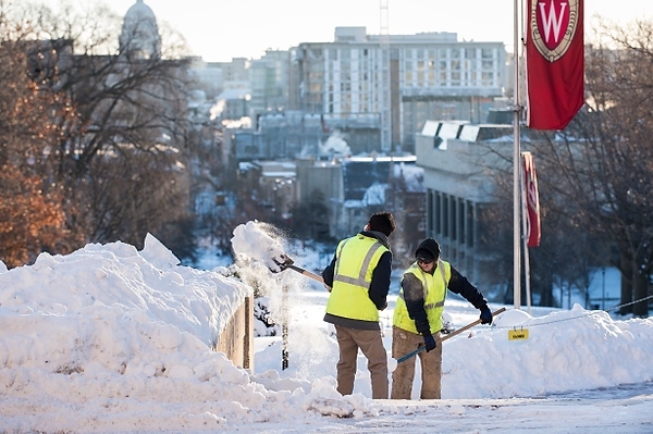 Photo: Grounds crew members shovel snow off Bascom