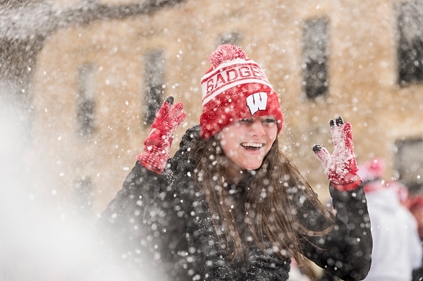 Photo: Battle for Bascom 2K15 participant raises her hands as snow falls overhead