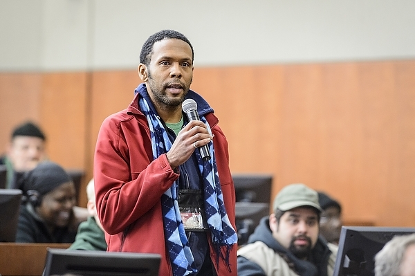 Photo: Ronald Mims, custodian in Facilities Planning and Management, presents a question to the chancellor