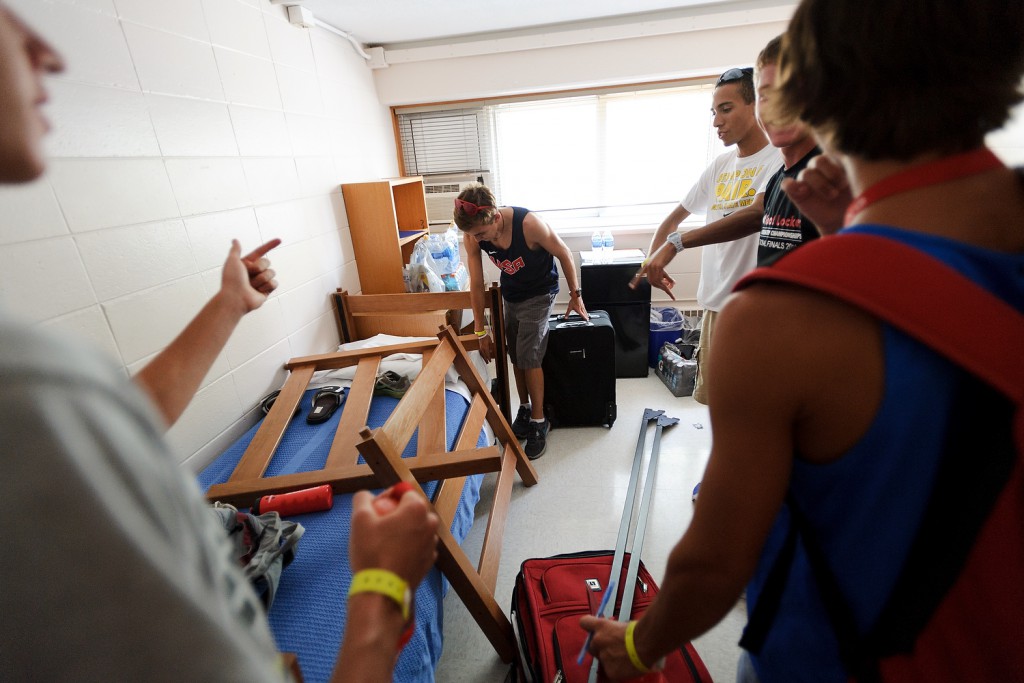 Demonstrating that friendship can conquer even the toughest challenge, students returning for another Camp of Champions experience reconfigure their bunk beds, hoping to stay together in one room at Sullivan Residence Hall.