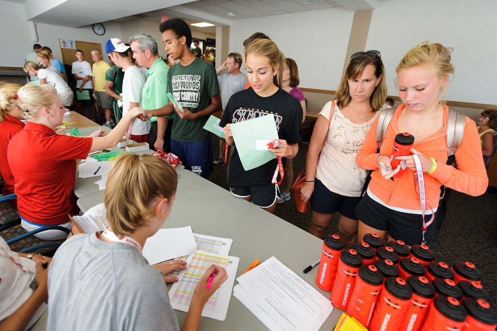 Runners from middle schools and high schools check in for the Camp of Champions, a co-ed camp now in its 40th year.