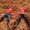 Who needs snow angels? Undergraduates Jenny Recktenwald, left, and Aubrey Nigh play among the fallen leaves near Elizabeth Waters Residence Hall.