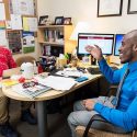 Quortne Hutchings (right), a college scholar advisor to students who are part of PEOPLE, meets with undergraduate Brian Allen in Hutchings’ office.