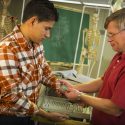 UW-Madison senior Christian Hernandez (left) and faculty associate Andrew Lokuta (right) are pictured in the Physiology 335 classroom. Lokuta has taken a new approach to better engage minority students in and beyond his course.