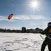 Undergraduate Ben Witman practices his snow-kiting skills during a Hoofer Sailing Club class on frozen and snow-covered Lake Mendota near the University of Wisconsin-Madison during winter on Feb. 26, 2015. The class had just advanced to their B-level rating, which includes snow kiting with a harness but boots rather than a windsurfing board. On the horizon is the dome of Wisconsin State Capitol building. (Photo by Jeff Miller/UW-Madison)