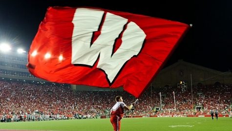 A member of the UW Spirit Squad hoists a motion W flag into the air following a UW touchdown during the Wisconsin vs UNLV football game at Camp Randall Stadium on Sept. 1, 2011. Wisconsin went on to win the game, 51-17. (Photo by Bryce Richter / UW-Madison)