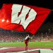 A member of the UW Spirit Squad hoists a motion W flag into the air following a UW touchdown during the Wisconsin vs UNLV football game at Camp Randall Stadium on Sept. 1, 2011. Wisconsin went on to win the game, 51-17. (Photo by Bryce Richter / UW-Madison)