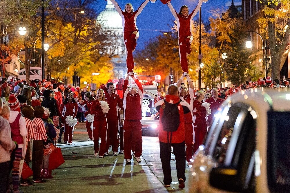 Members of the UW Spirit Squad performed one of their trademark balancing acts for the crowd with the illuminated State Capitol in the background.