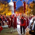 Members of the UW Spirit Squad performed one of their trademark balancing acts for the crowd with the illuminated State Capitol in the background.