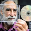 Soon-to-retire faculty member Jim Leary, professor of folklore and Scandinavian studies, peers through the liner-note section of a CD case in his office at Sterling Hall. Leary was recently nominated for a Grammy Award in the category of 