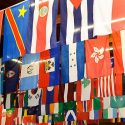 Photo: Flags of various countries hanging vertically from poles