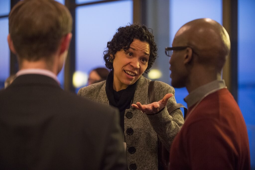 Marah Curtis, associate professor of social work, speaks with Dereck Barr-Pulliam, assistant professor of accounting, during the Faculty of Color Reception in February 2015. 
