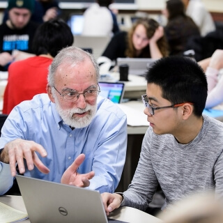 John Moore, the W.T. Lippincott Professor of Chemistry, works with undergraduate student Jiayu Wang during a chemistry class discussion section in Sterling Hall at the University of Wisconsin-Madison on Feb. 3, 2016. Moore is one of twelve 2016 Distinguished Teaching Award recipients. (Photo by Jeff Miller/UW-Madison)