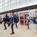 A graduate performs a step routine with his Phi Beta Sigma fraternity brothers following UW-Madison's 2015 winter commencement ceremony.