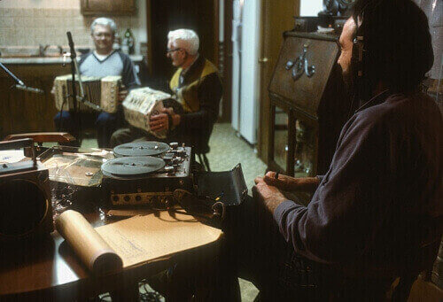 Father and son Irving (center) and Robert DeWitz play concertina as folklorist Jim Leary records the session in Robert's basement. 