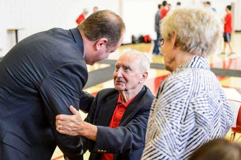 Greg Gard, left, talks with Jim and Pauline Nedelcoff after being announced the 16th head coach of the Wisconsin Badgers men's basketball team Tuesday. Gard began his career under Coach Nedelcoff at Southwestern High School in Hazel Green, Wis.