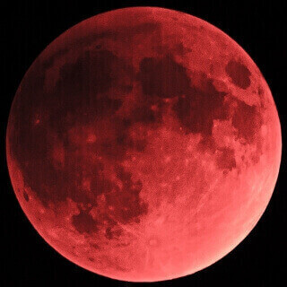 Glowing red moon against black background